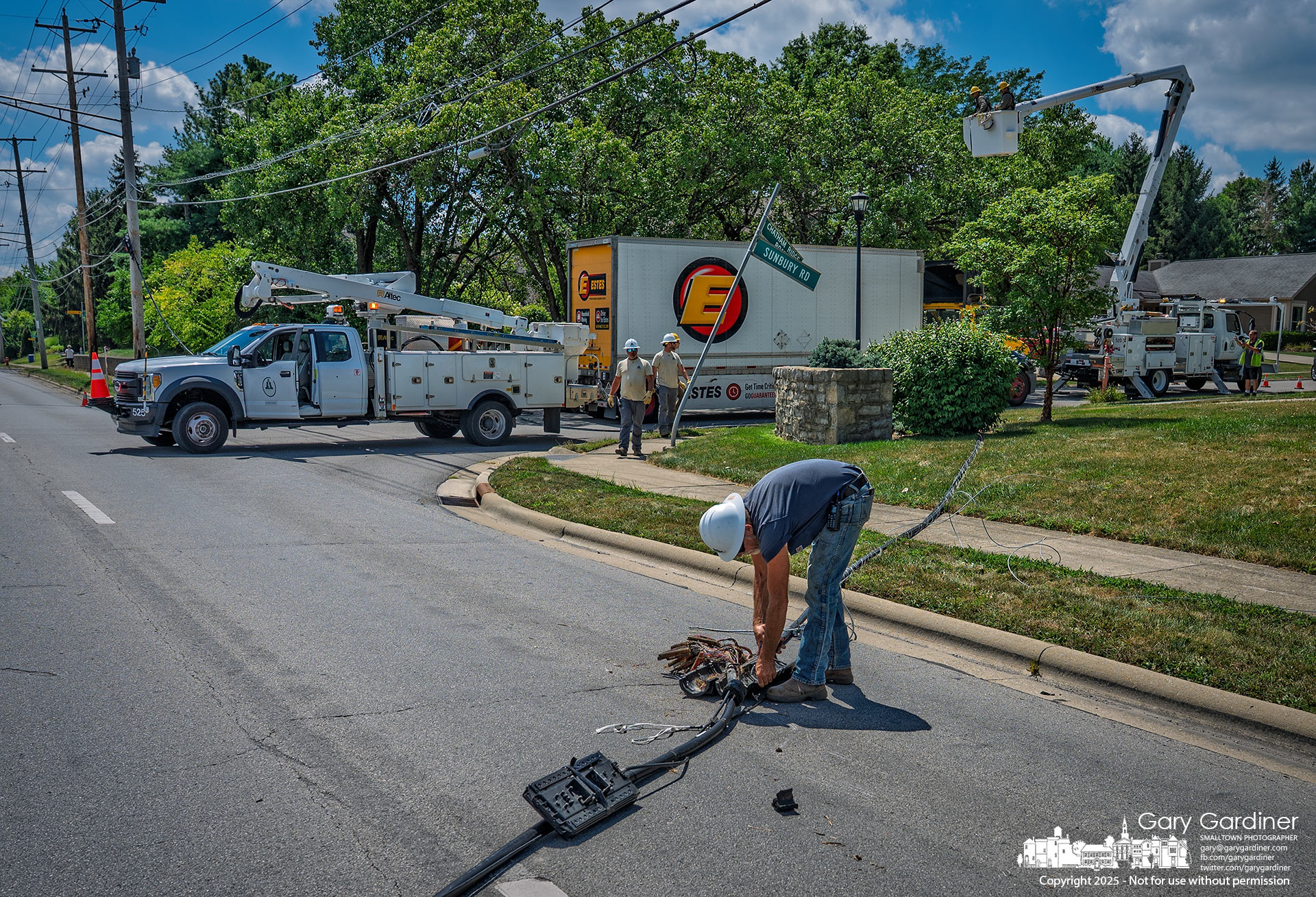 Crews and trucks at Sunbury Rd and Chatham Ridge after a low cable was pulled down.