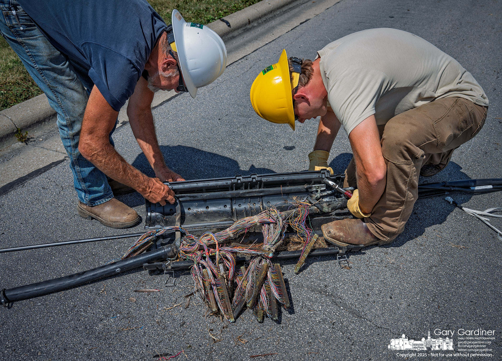 Technicians open a splice case to assess the bundle.