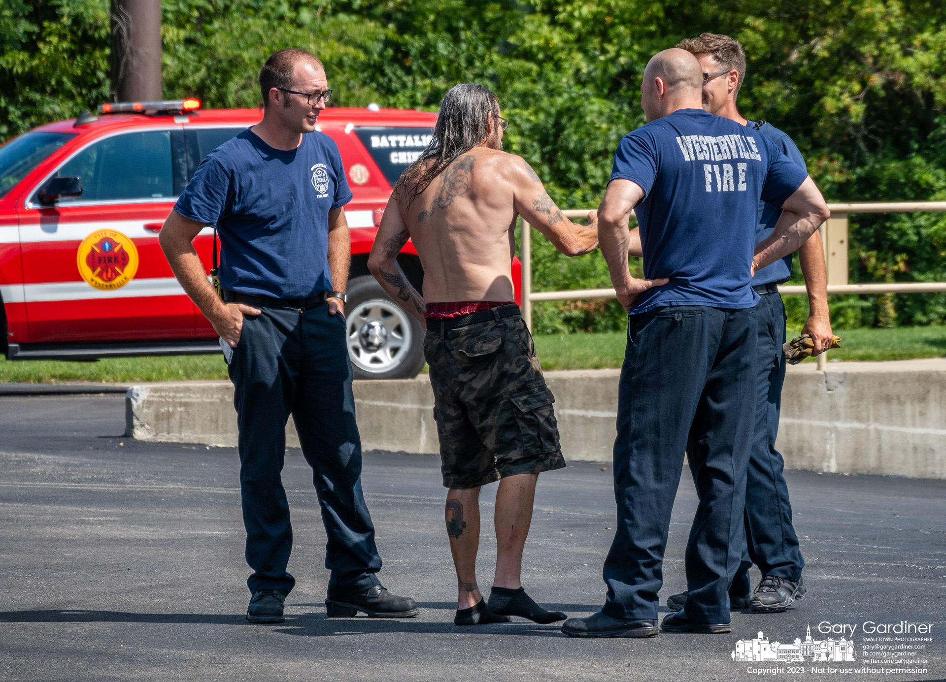 A man who intentionally rode his kayak over the low head dam at Alum Creek Park North in Westerville offers a thank you and a handshake to some of the Westerville firefighters who came to his aid. The kayak remained trapped in the swirl below the dam after he gave his phone to a bystander telling her take a video as he went over the dam in the kayak. He became separated from the kayak and tumbled for a few minutes until he was able to get away from the dam. He was wearing a personal flotation device. His phone was eventually returned to him with a suggestion by police and fire to not attempt another trip over the dam.
